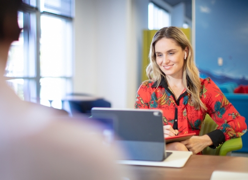 Woman using 8x8 application across devices to access cloud communications and work from anywhere